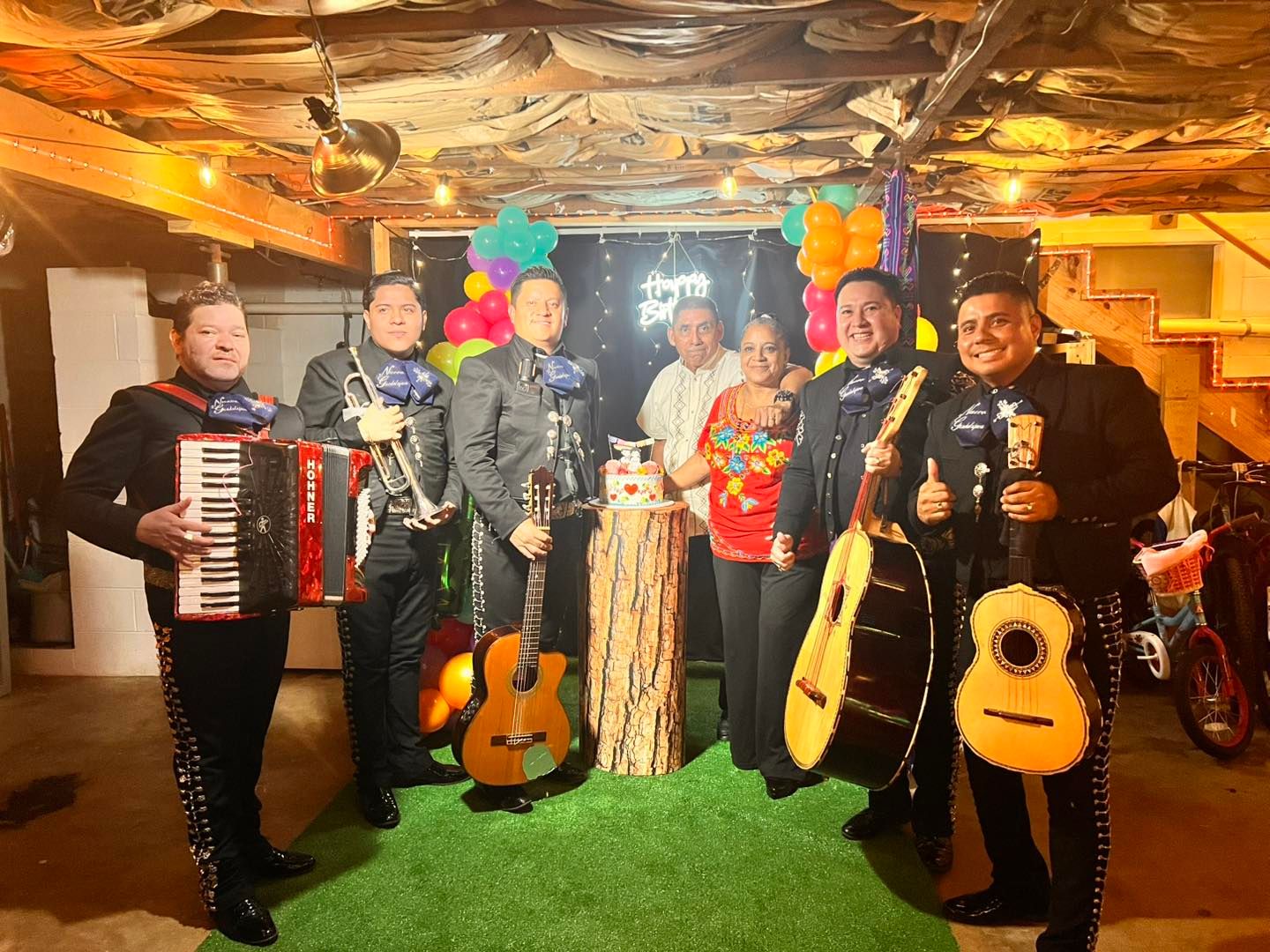 Mariachi with a family during a birthday celebration.