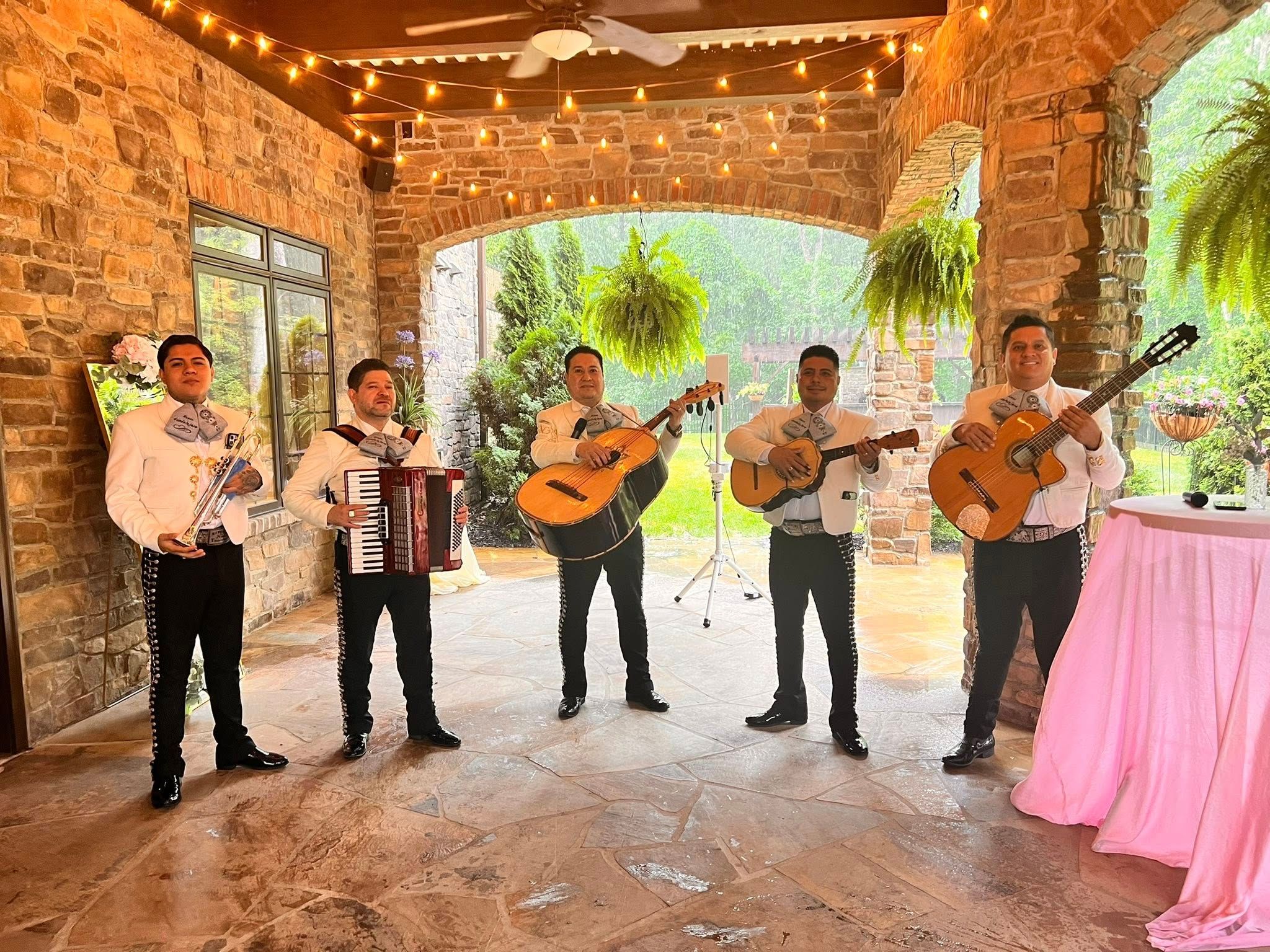 Mariachi Nuevo Guadalajara NC with their instruments during a celebration.